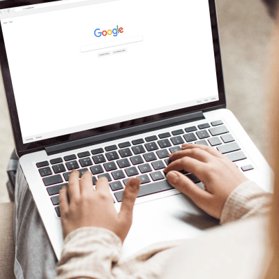stylish professional woman is ready to Google something on her laptop