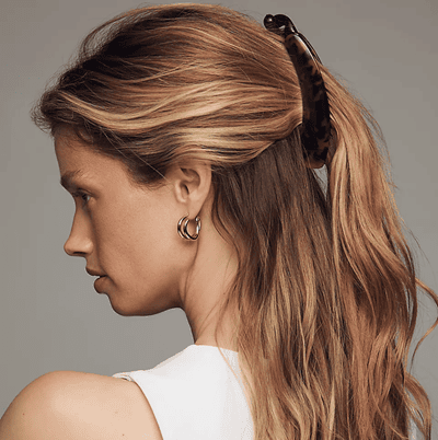 woman wears banana claw clip in a tortoiseshell print