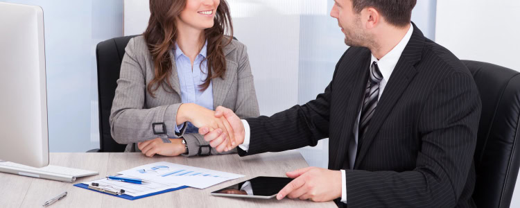 young professional woman (possibly a summer associate or law firm intern) shaking hands with an older man in a suit