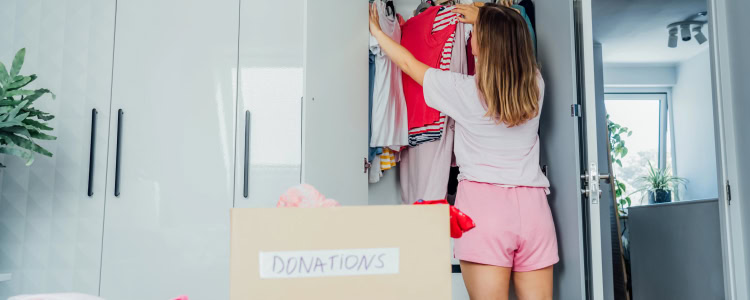 woman wears casual shorts and t-shirt while doing a closet purge and hoping she doesn't have regrets about getting rid of her workwear