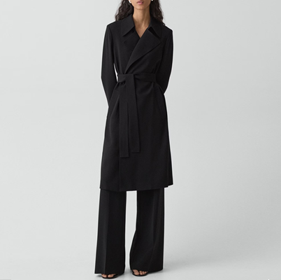 woman wears black belted trench coat