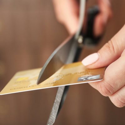 woman cuts a credit card in half
