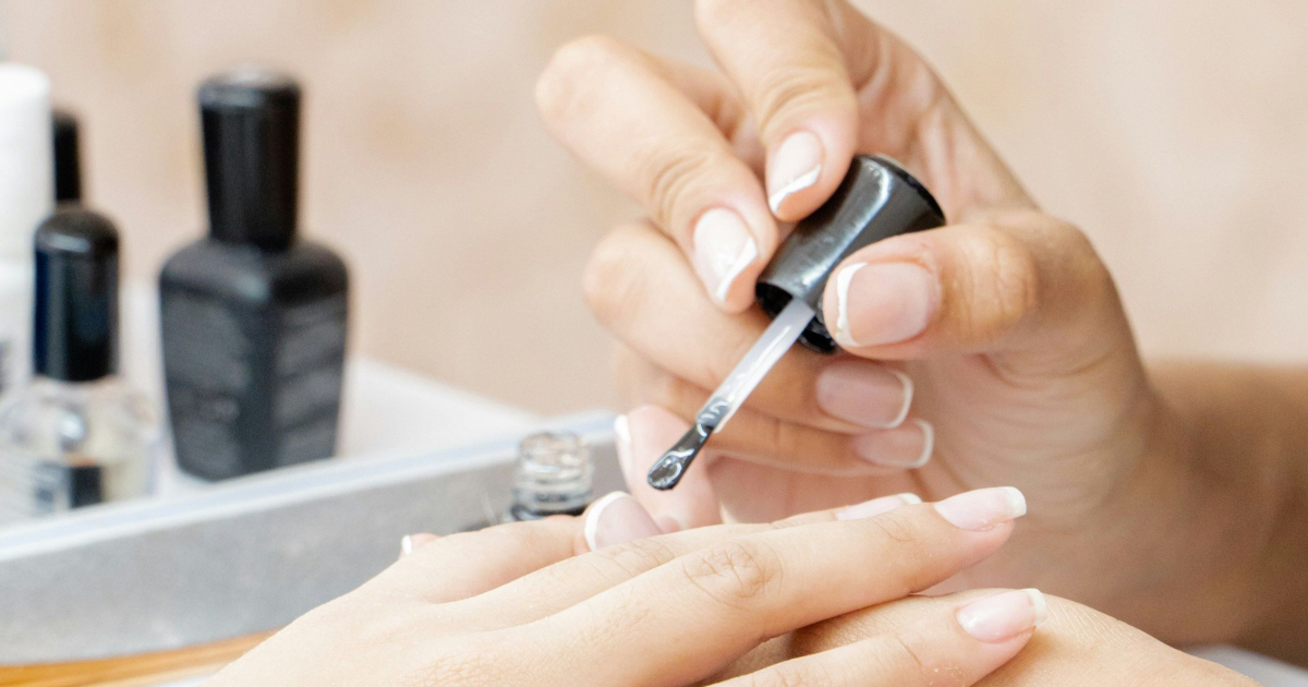 woman gets a manicure (close up shot of hands)