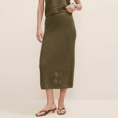 woman wears crocheted olive midi skirt where the bottom half of the skirt doesn't have a slip