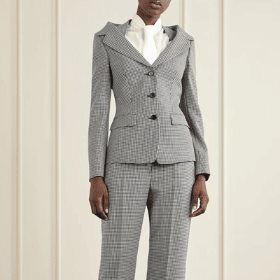 woman wears black and white checked suit