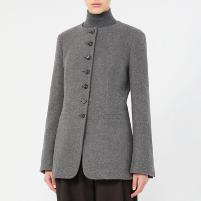 woman wears stylish cutaway collarless blazer
