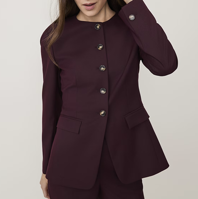 woman wears stylish cutaway collarless blazer