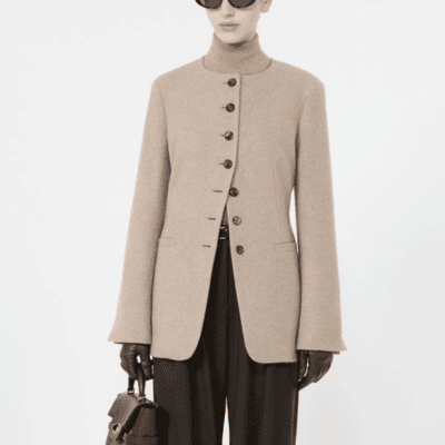 woman wears stylish cutaway collarless blazer