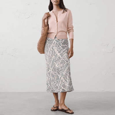 woman wears grey print midi skirt with buttoned cardigan