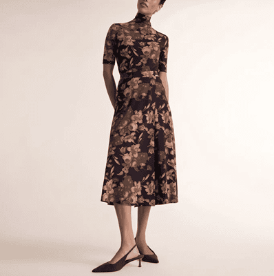 woman wears brownish midi skirt with matching top