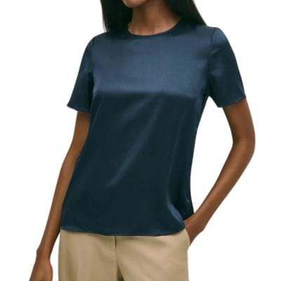 A woman wearing a navy short-sleeved top and khaki pants