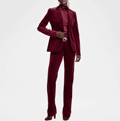 Black woman wears red velvet suit with red turtleneck and boots